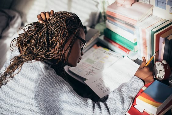 Student in classroom taking notes